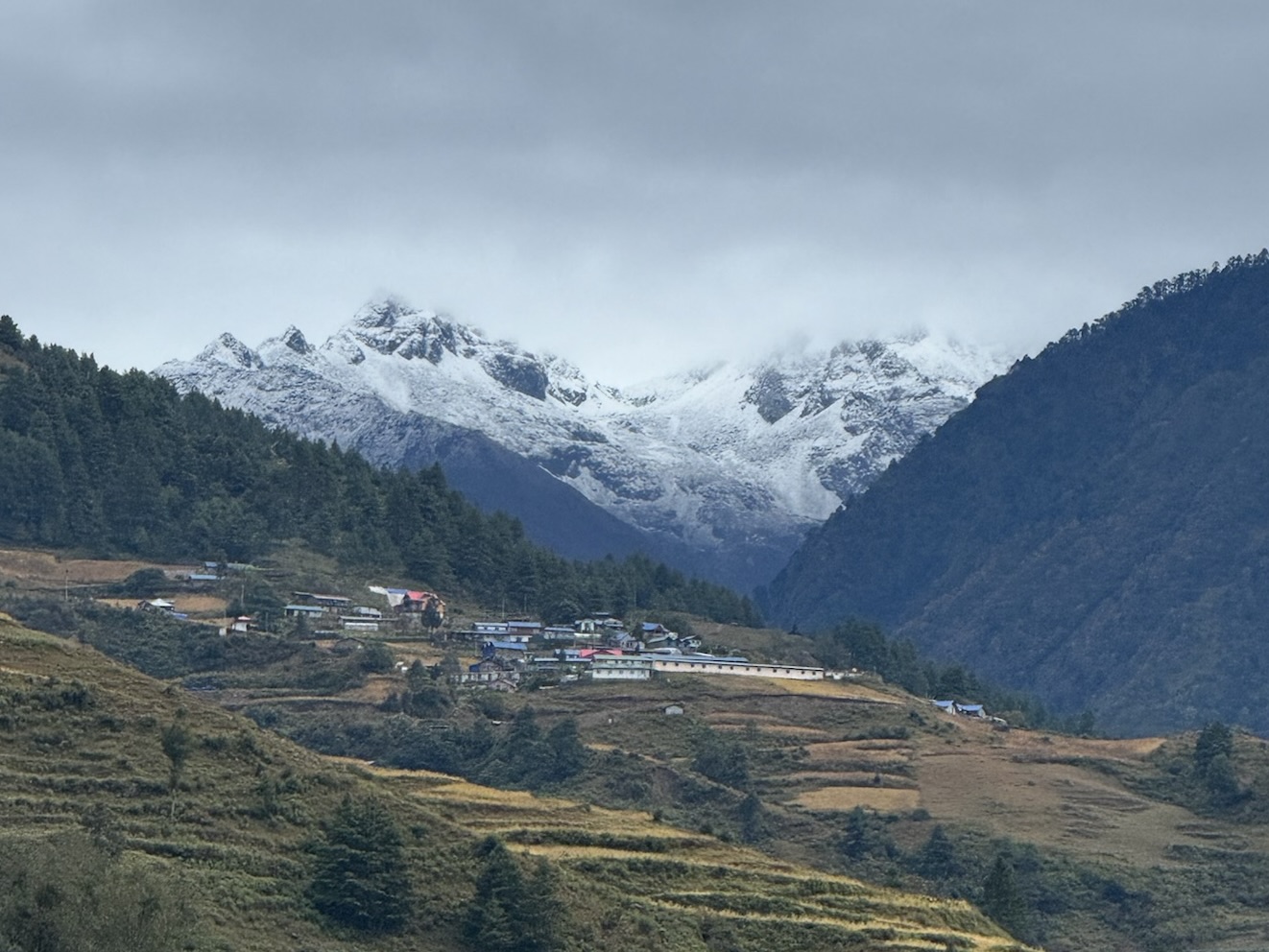 Remote village in the Himalayas of Nepal with snow-capped mountains